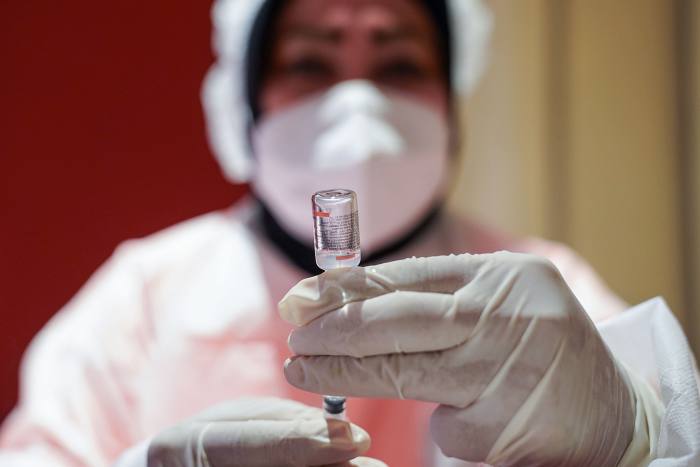 A healthcare worker prepares a dose of the Sinovac Biotech Ltd. Covid-19 vaccine
