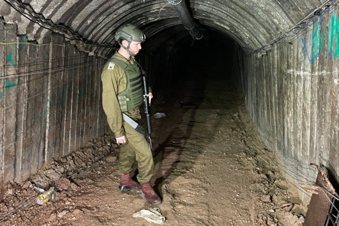 An Israeli soldier stands in a section of tunnel built by Hamas under Gaza, on December 15 2023