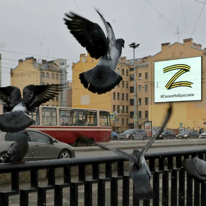 A large letter Z on a billboard, seen above wrought-iron railings