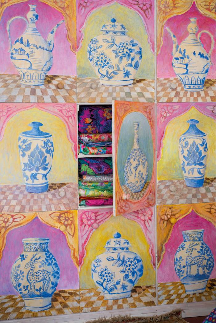 Painted cabinets in the living room of textile designer Kaffe Fassett