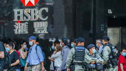 Riot police stand guard in Hong Kong’s central business district in May. Senior members of the city’s government are said to be finding it increasingly difficult to bank with foreign institutions