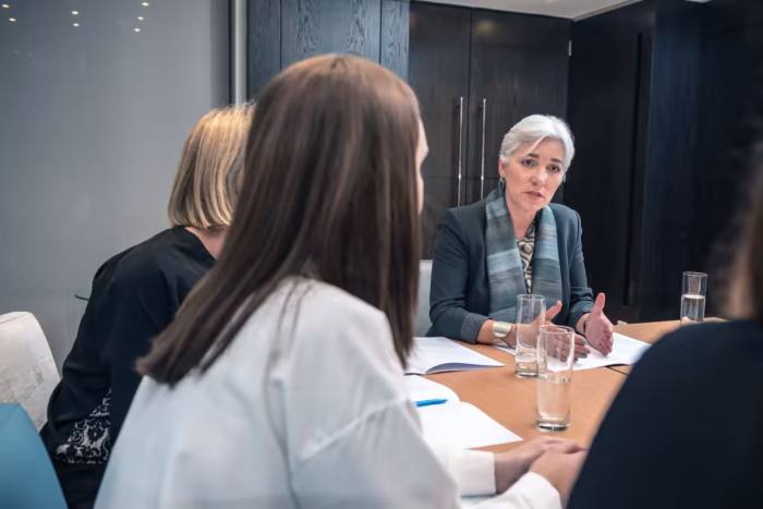 Susan Room coaches three women in a meeting room