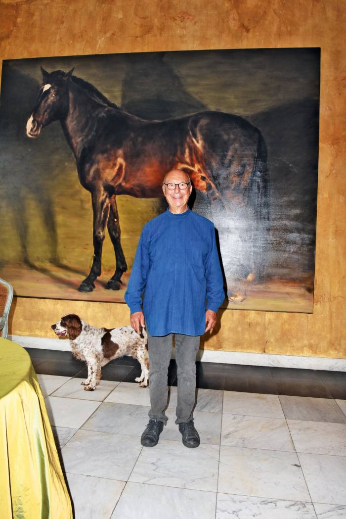Vervoordt in the hallway at ‘s-Gravenwezel with his English springer spaniel Inu, in front of a painting of his horse by the Belgian artist Michaël Borremans