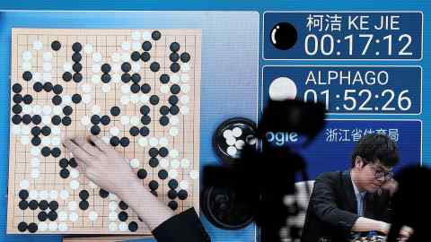 A screen displays the match featuring Chinese Go player Ke Jie against Google’s artificial intelligence program AlphaGo