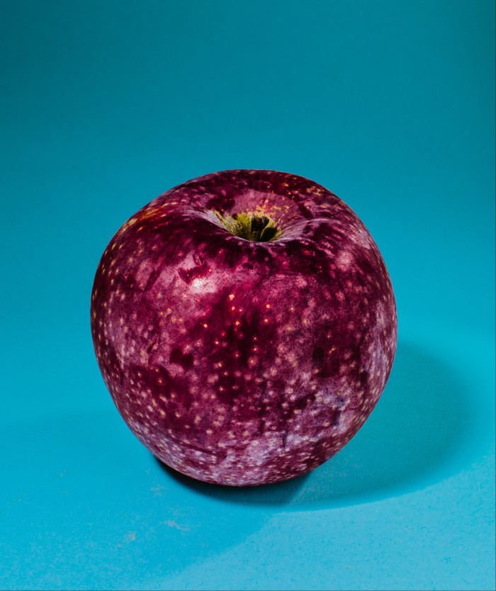 A red apple with some white spots on the skin