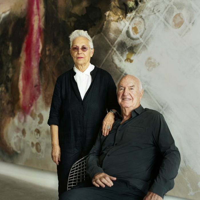 Mera and Don Rubell at the Rubell Museum - behind them is Lucy Dodd's 