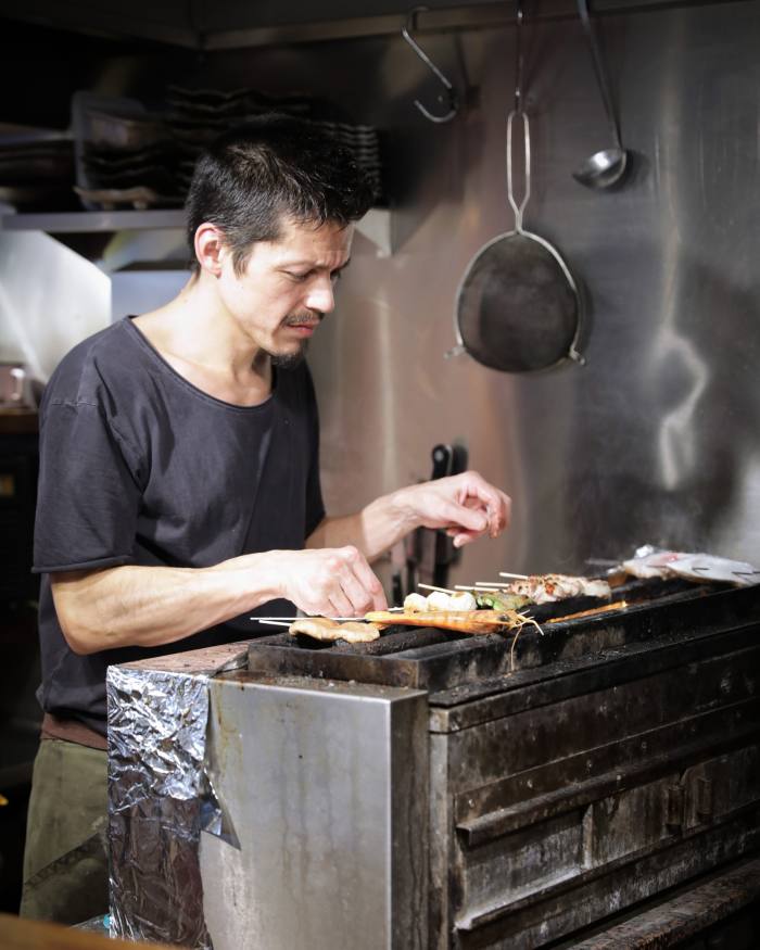 Jin Kichi's chef, Oliver Billingsley, cooks on the grill