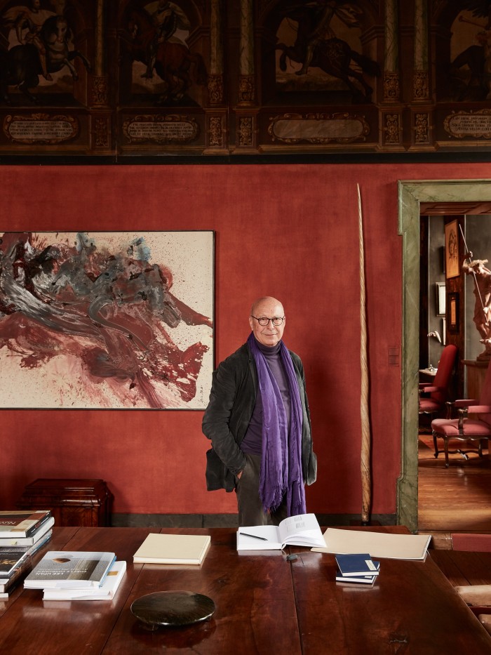 Axel Vervoordt in his study with a Gutai painting