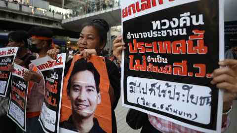 Supporters hold a photo of Pita Limjaroenrat, a prime ministerial candidate blocked by Thailand's National Assembly
