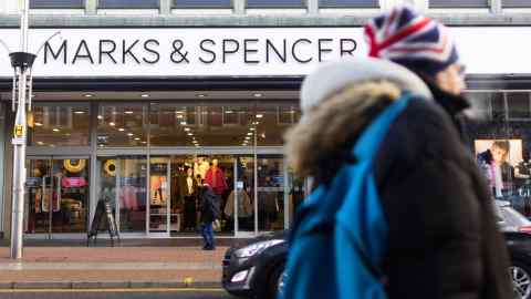 Shoppers pass a Marks and Spencer retail store on the high street in Southend-on-Sea