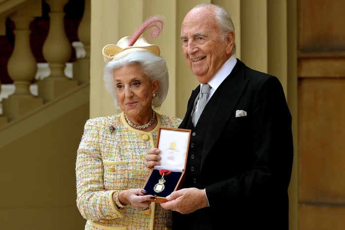Young and his wife, Lita, after he was presented with his insignia of member of the Order of the Companions of Honour by the Prince of Wales in 2015