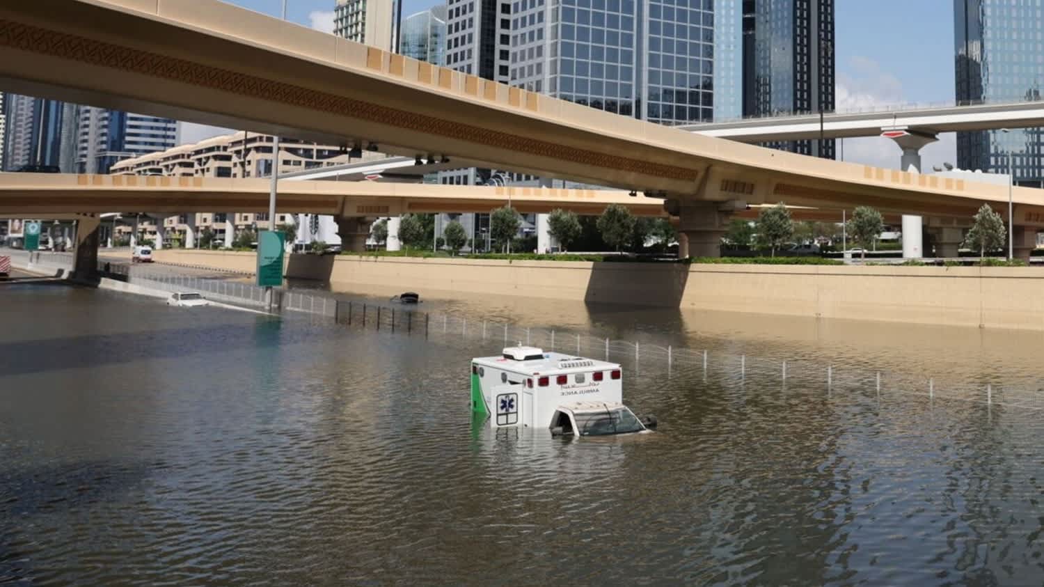 An abandoned ambulance submerged in flood water on a highway after a rainstorm in Dubai, United Arab Emirates