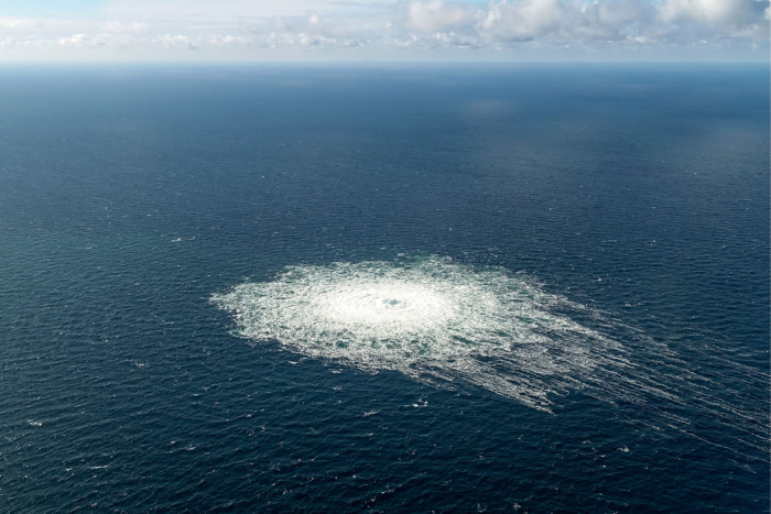 A big circle of white on in the sea as gas bubbles up the surface from the broken pipeline