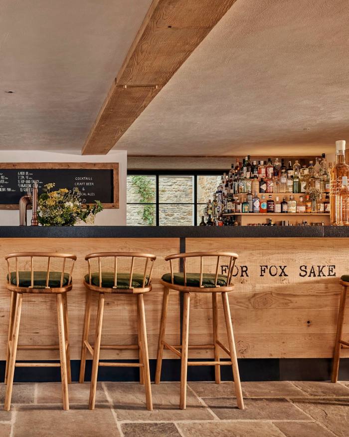 Seats at the wooen bar, on which it reads ‘For Fox Sake’