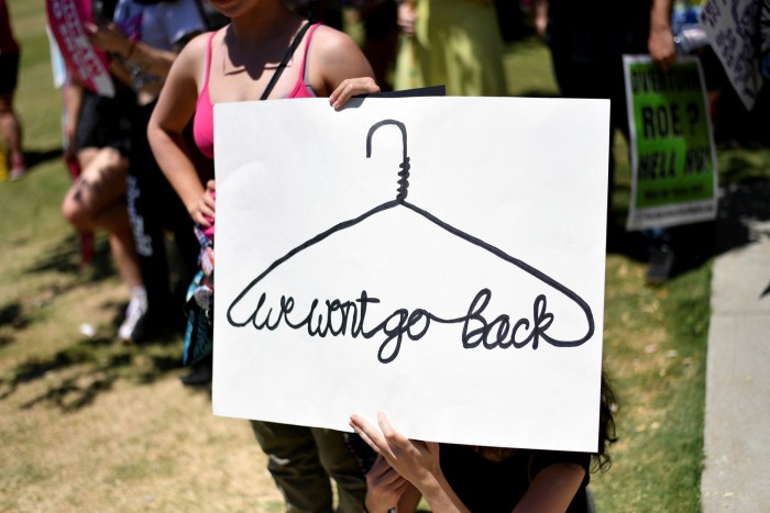 An abortion-rights activist holds a placard saying “we will not go back” at a reproductive rights rally