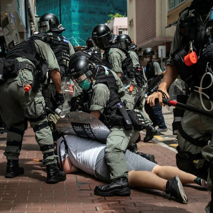A man is detained by riot police during a demonstration in July in Hong Kong