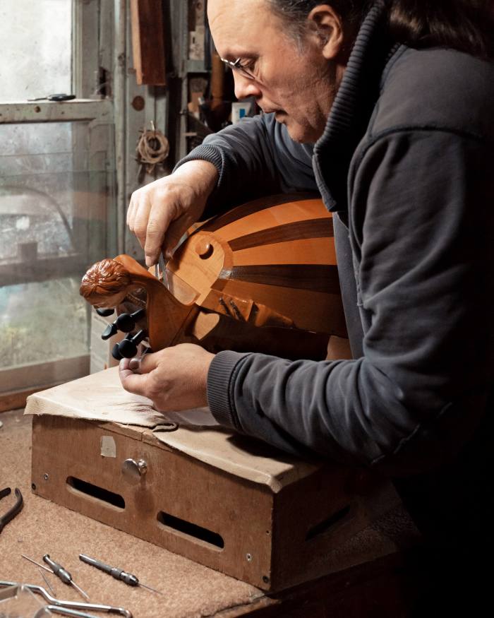 Chris Allen stringing a new hurdy-gurdy