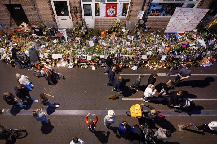 Flowers placed at the spot where Dutch journalist Peter R de Vries was shot in Amsterdam