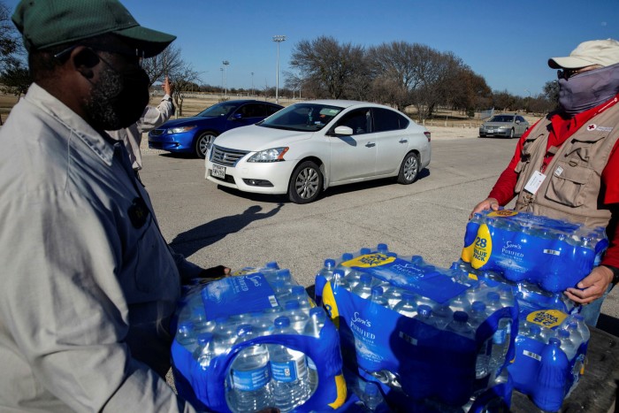 Parks employees and American Red Cross volunteers distribute water after winter storms cut service in Dallas