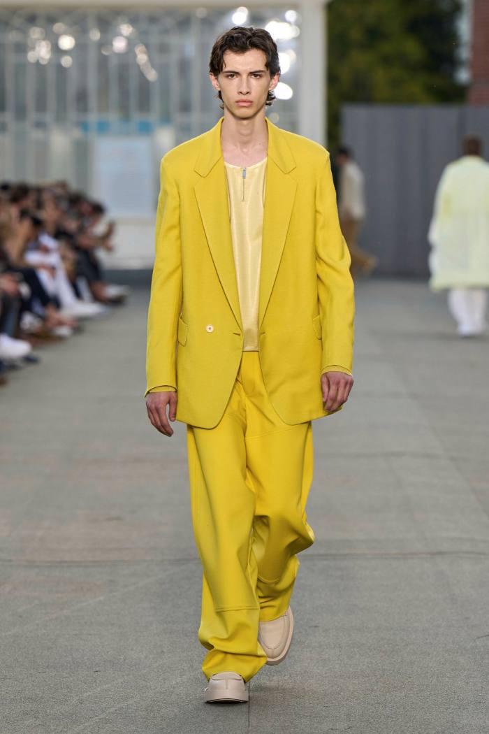 A man models a bright yellow suit