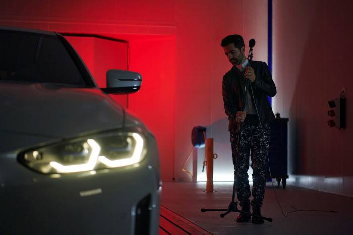 Renzo Vitale, BMW's creative director of sound, stands next to a vehicle