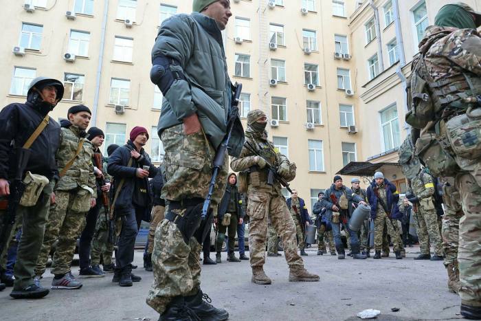 Ukrainian Territorial Defense fighters wait for an order in the city of Kharkiv