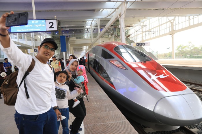 Passengers prepare to board a high-speed train