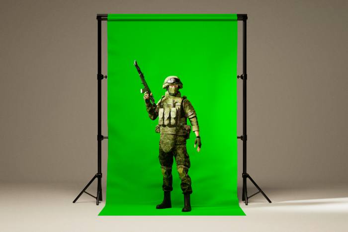 soldier poses in front of a green screen