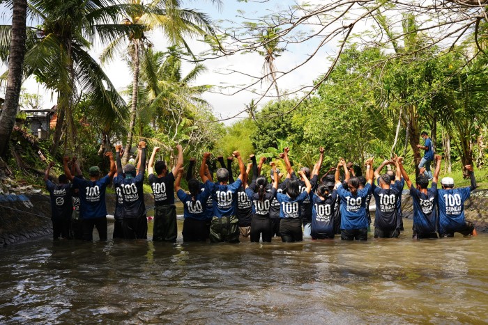 The Sungai Watch team celebrating the 100th floating trash barrier installed in Bali in August 2021