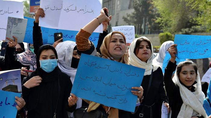 Afghan women and girls take part in a protest in front of the Ministry of Education in Kabul on March 26 2022, demanding that high schools be reopened for girls