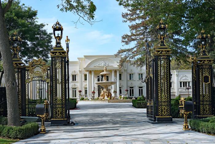 A European-style mansion behind its open gates in Toronto’s Bridle Path neighbourhood