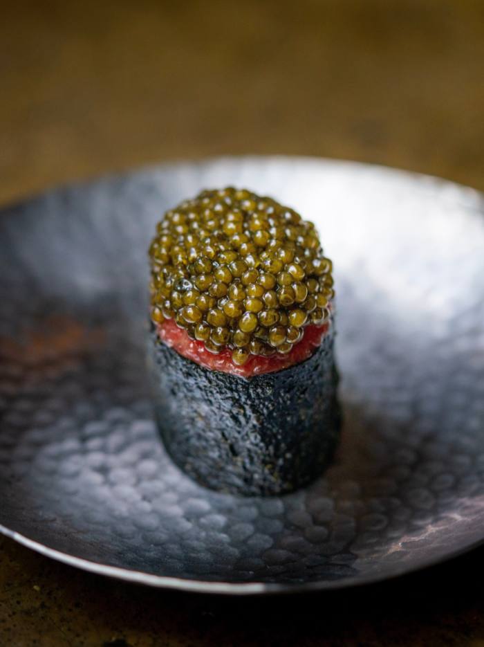 Jua’s Caviar Kim – a seaweed-wrapped roll topped with caviar – sitting on a small metal dish