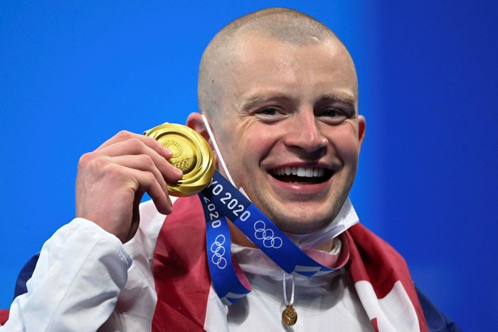 British swimmer Adam Petty poses with the gold medal in the men's 100m breaststroke