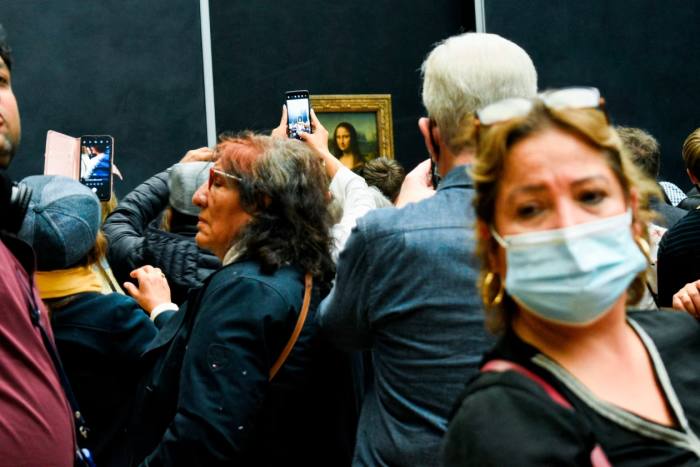 Visitors to the Louvre in Paris crowd in front of the Mona Lisa in May 2022