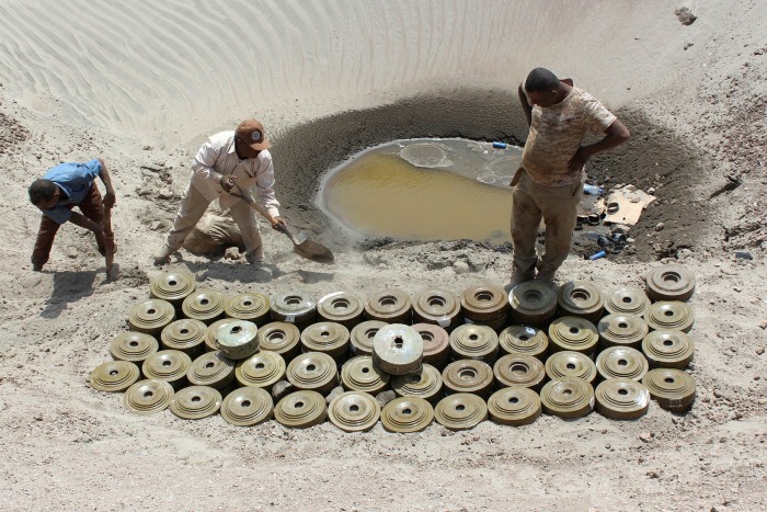 Yemeni demining experts prepare for a controlled explosion to destroy explosives and mines laid by Houthi rebels