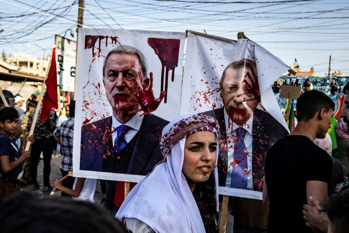 Syrian Kurds hold defaced portraits of Recep Tayyip Erdoğan and defence minister Hulusi Akar as they demonstrate in the northeastern Syrian city of Qamishli against the Turkish offensive on Kurdistan Workers’ Party (PKK) areas in northern Iraq on June 10 2021