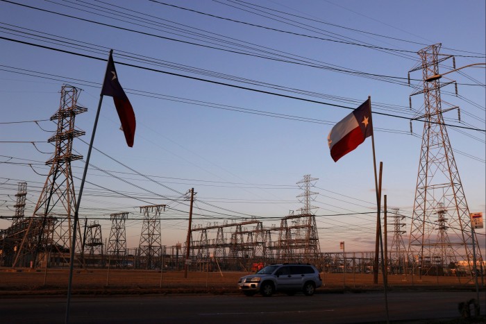 Texas flags fly near an electrical substation