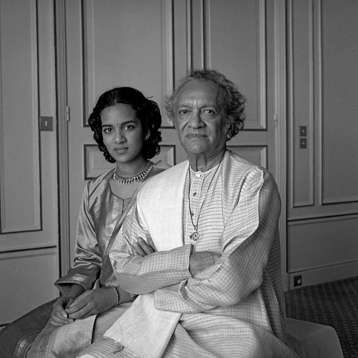 A young woman, Anoushka Shankar, sitting with her father, Ravi, both smiling