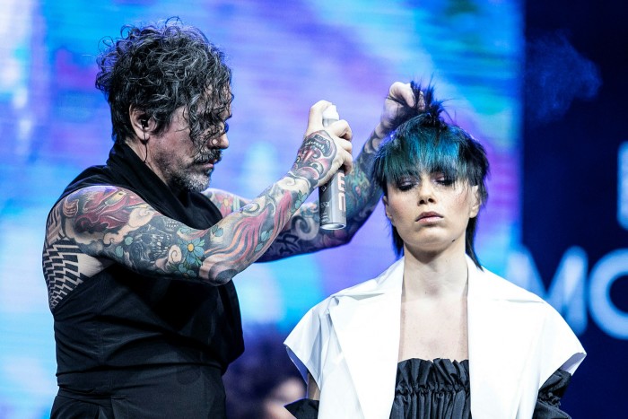 Styling Creative Director Wella Professionals Italy, Rudy Mostarda is seen styling a model’s hair during the “On Hair Show & Exhibition” held at BolognaFiere Exhibition Centre in Italy