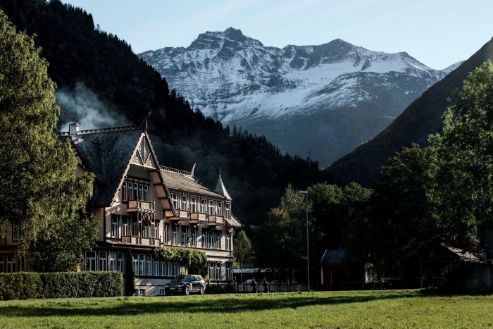Gabled three-storey hotel set against a mountain backdrop