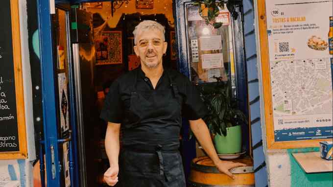 Antonio Jose Pereirz in the doorway of his Tostas & Bacalao bar in the Madrid district of Lavapiés