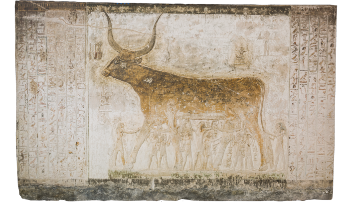 Recreation of a painted cow with large horns on a background of hieroglyphics