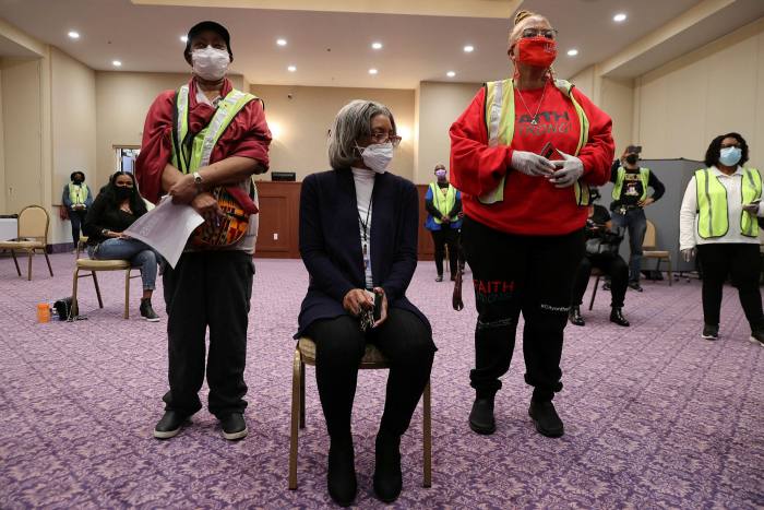Volunteers monitor people after they received their first dose of the Moderna vaccine in Maryland, US, in March 