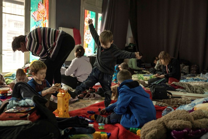 Children play with toys as displaced families from the Luhansk region take shelter at a puppet theater in Lviv