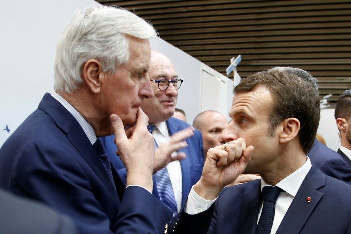 Michel Barnier, left, talks with President Emmanuel Macron