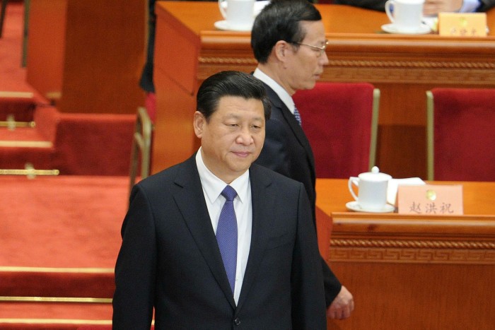 Zhang Gaoli walks past President Xi Jinping at the Great Hall of the People in Beijing in 2014