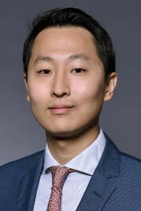 Studio portrait of Aaron Yoon in shirt, tie and jacket