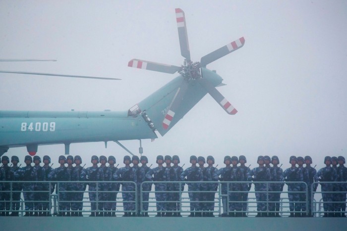 Soldiers stand on deck of the ambitious transport dock Yimen Shan of the Chinese People’s Liberation Army (PLA) Navy as it participates in a naval parade. China’s navy is now by far the largest in the world