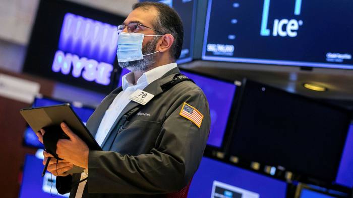 Trader Aman Patel works on the floor of the NYSE