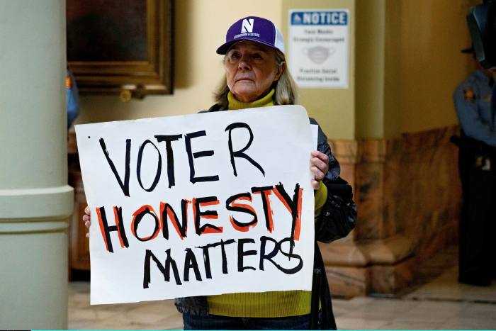 A woman demonstrates in support of voter restrictions on March 8 in the Capitol building in Atlanta, Georgia